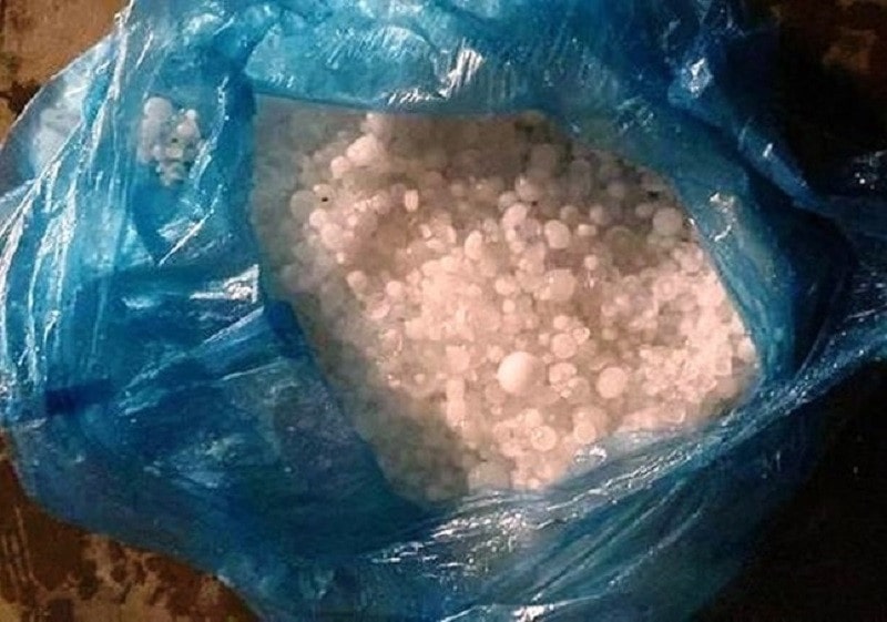 Sau trận mưa, người dân địa phương gom những hạt mưa kết đông bỏ vào túi nilon.