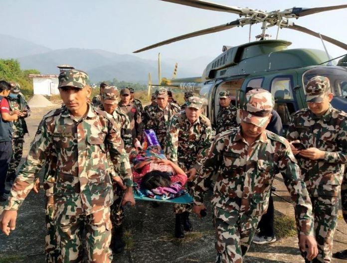 Quan nhan khieng mot nguoi bi thuong tren min - Động đất ở Nepal: Ít nhất 157 người chết, thương vong tiếp tục gia tăng; Thủ tướng Ấn Độ gửi thông điệp