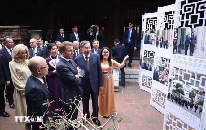 Tổng B&iacute; thư T&ocirc; L&acirc;m v&agrave; Phu nh&acirc;n c&ugrave;ng Tổng thống Ph&aacute;p Emmanuel Macron v&agrave; Phu nh&acirc;n xem trưng b&agrave;y ảnh về những dấu mốc ti&ecirc;u biểu trong quan hệ giữa hai nước, do Th&ocirc;ng tấn x&atilde; Việt Nam thực hiện.