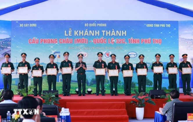 Đại tướng Phan Văn Giang, Bộ trưởng Bộ Quốc ph&ograve;ng tặng bằng khen cho c&aacute;c tập thể v&agrave; c&aacute; nh&acirc;n c&oacute; th&agrave;nh t&iacute;ch xuất sắc trong thi c&ocirc;ng dự &aacute;n cầu Phong Ch&acirc;u mới. (Ảnh: Dương Giang/TTXVN)