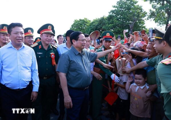 Thủ tướng Phạm Minh Ch&iacute;nh với nh&acirc;n d&acirc;n khu vực dự &aacute;n cầu Phong Ch&acirc;u mới tr&ecirc;n Quốc lộ 32C. (Ảnh: Dương Giang/TTXVN)